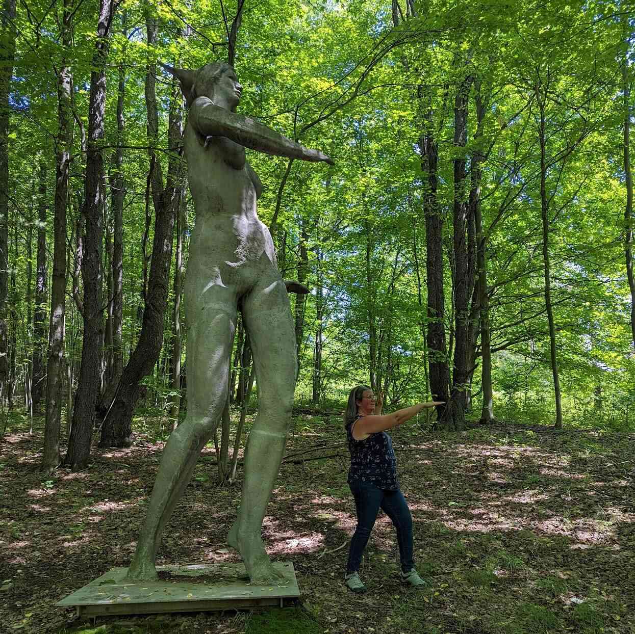 Debi posing with a sculpture at Griffis Sculpture Park