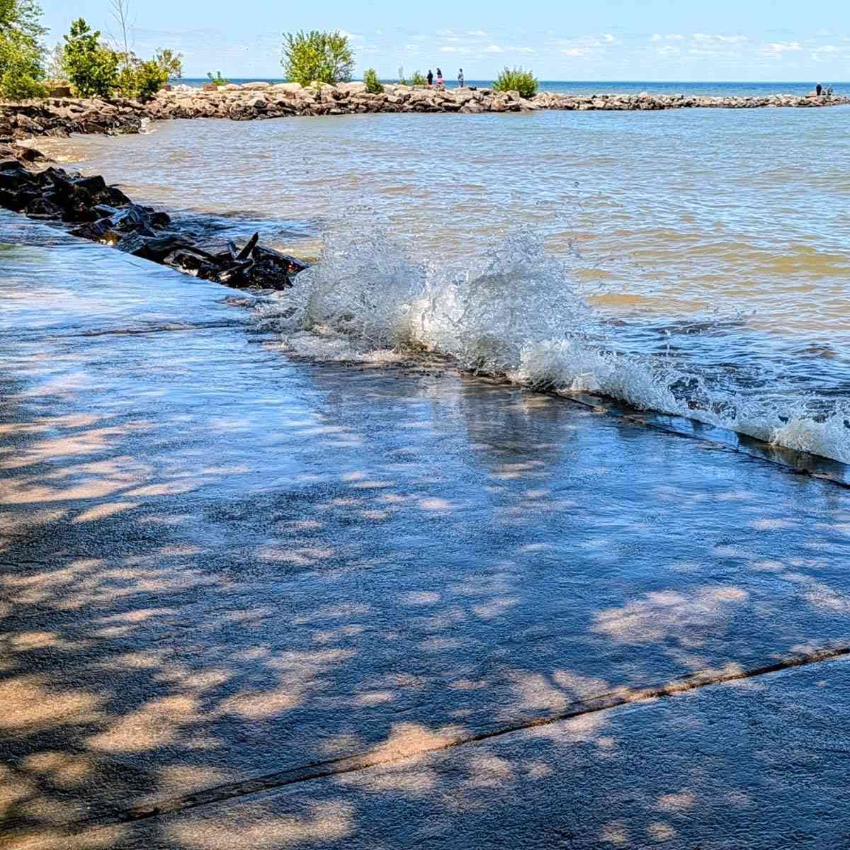 Water splashing against a break wall at Hamlin Beach State Park
